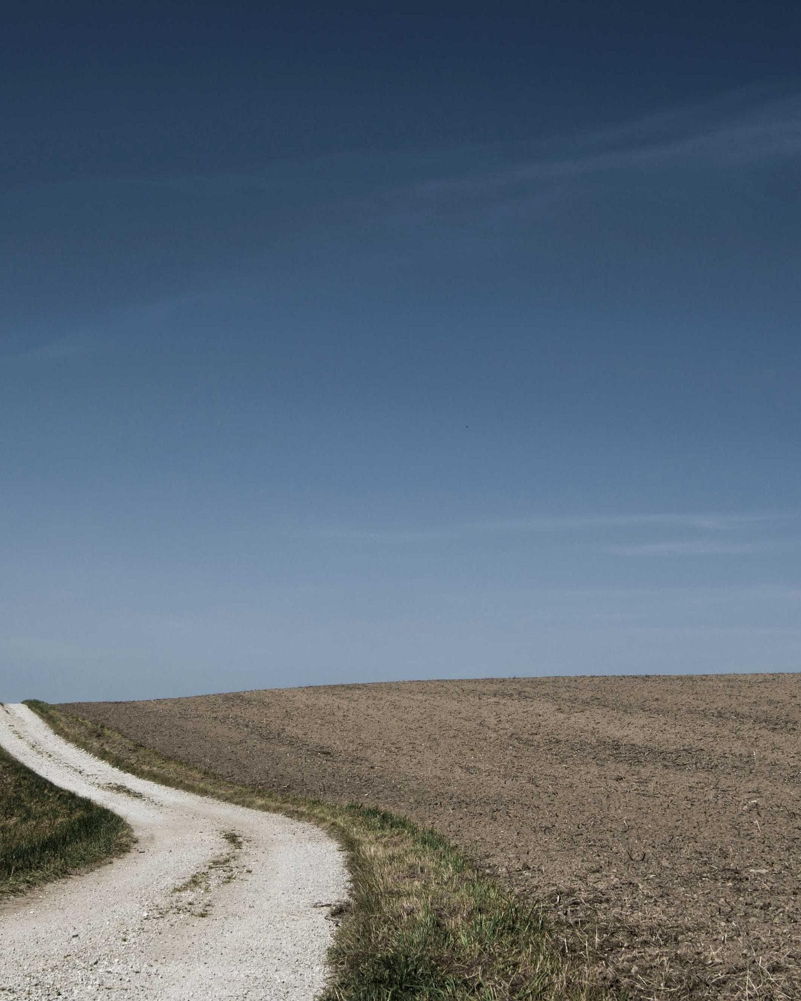 A track curving across open land